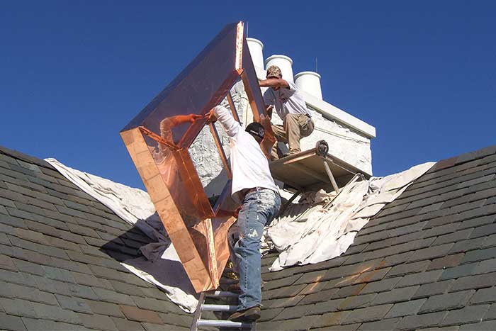 Technicians setting up to perform renovations on a chimney system