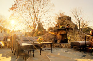 Beautiful outdoor fireplace on patio in the fall 